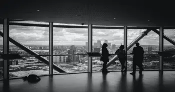 people at the window in a high-rise building
